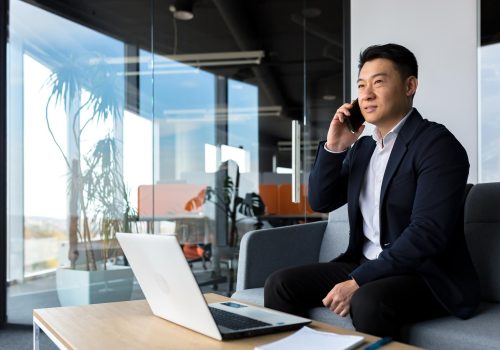 thinking-asian-businessman-businessman-talking-phone-working-modern-office-listening-seriously